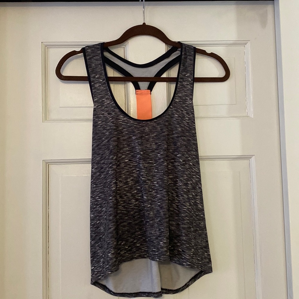 Racer back work out tank with neon orange detail on back.
